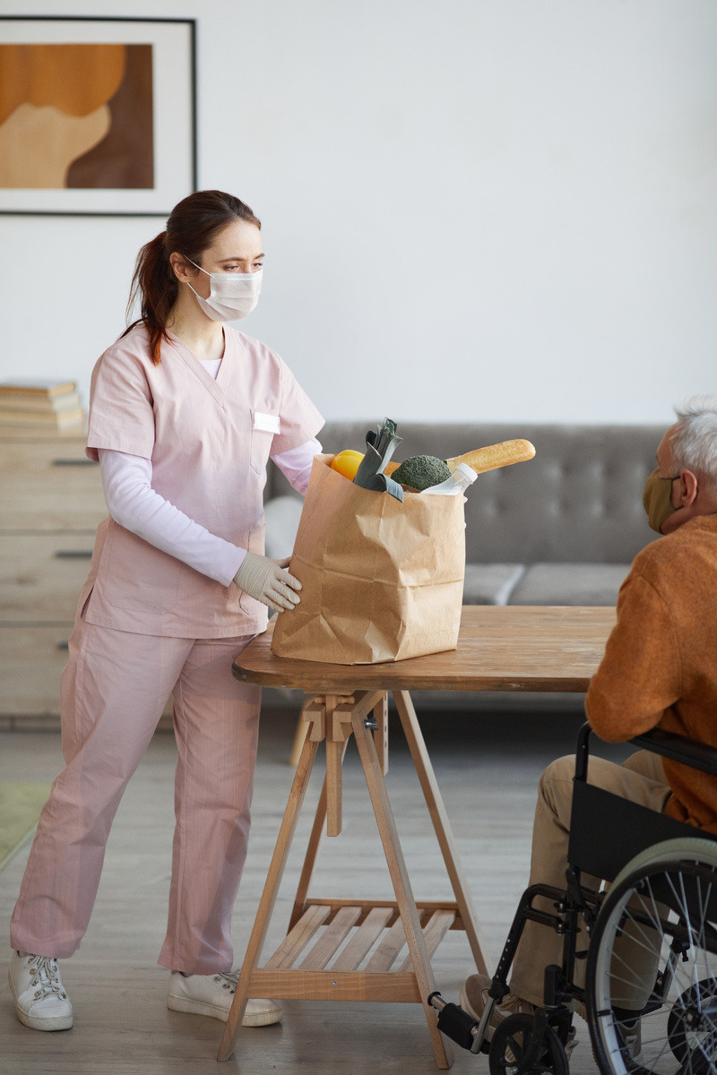 female-nurse-delivering-food-to-senior-people-2023-11-27-04-56-33-utc-1