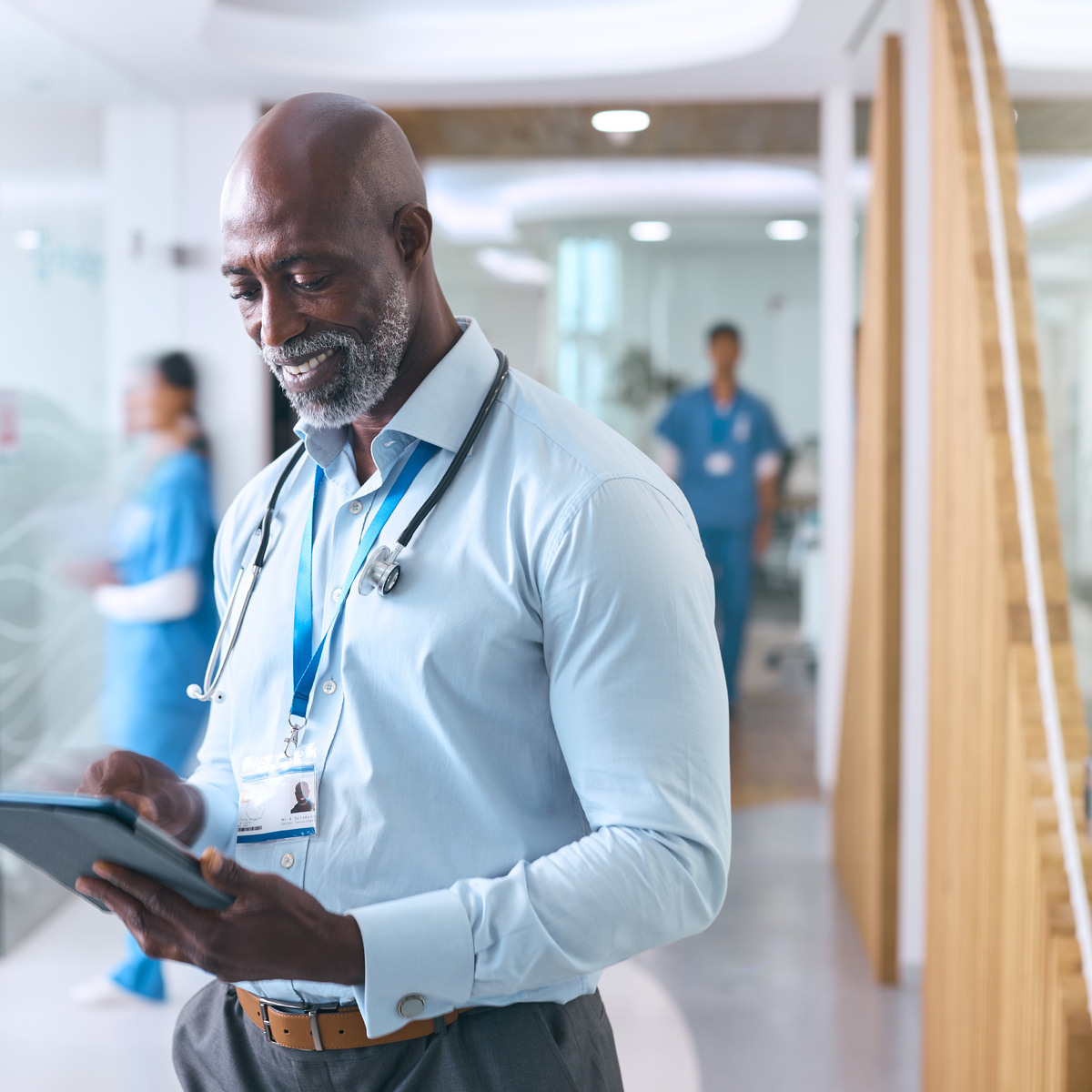 mature-male-doctor-with-digital-tablet-in-hospital-2024-10-19-06-44-17-utc-1