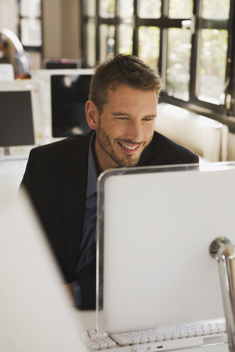 business-man-in-office-using-laptop-portrait-2024-09-15-16-40-54-utc-1