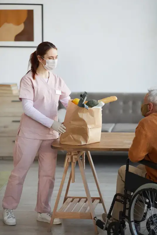 female-nurse-delivering-food-to-senior-people-2023-11-27-04-56-33-utc-1-reduced-size